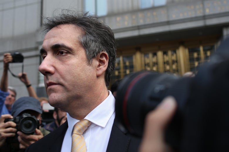 Michael Cohen surrounded by cameras in front of a courthouse.